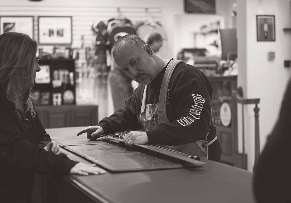 Gunsmith Jim Bellegarde examining customer's premium shotgun at Cole Fine Guns and Gunsmithing Harpswell, Maine Gun Shop